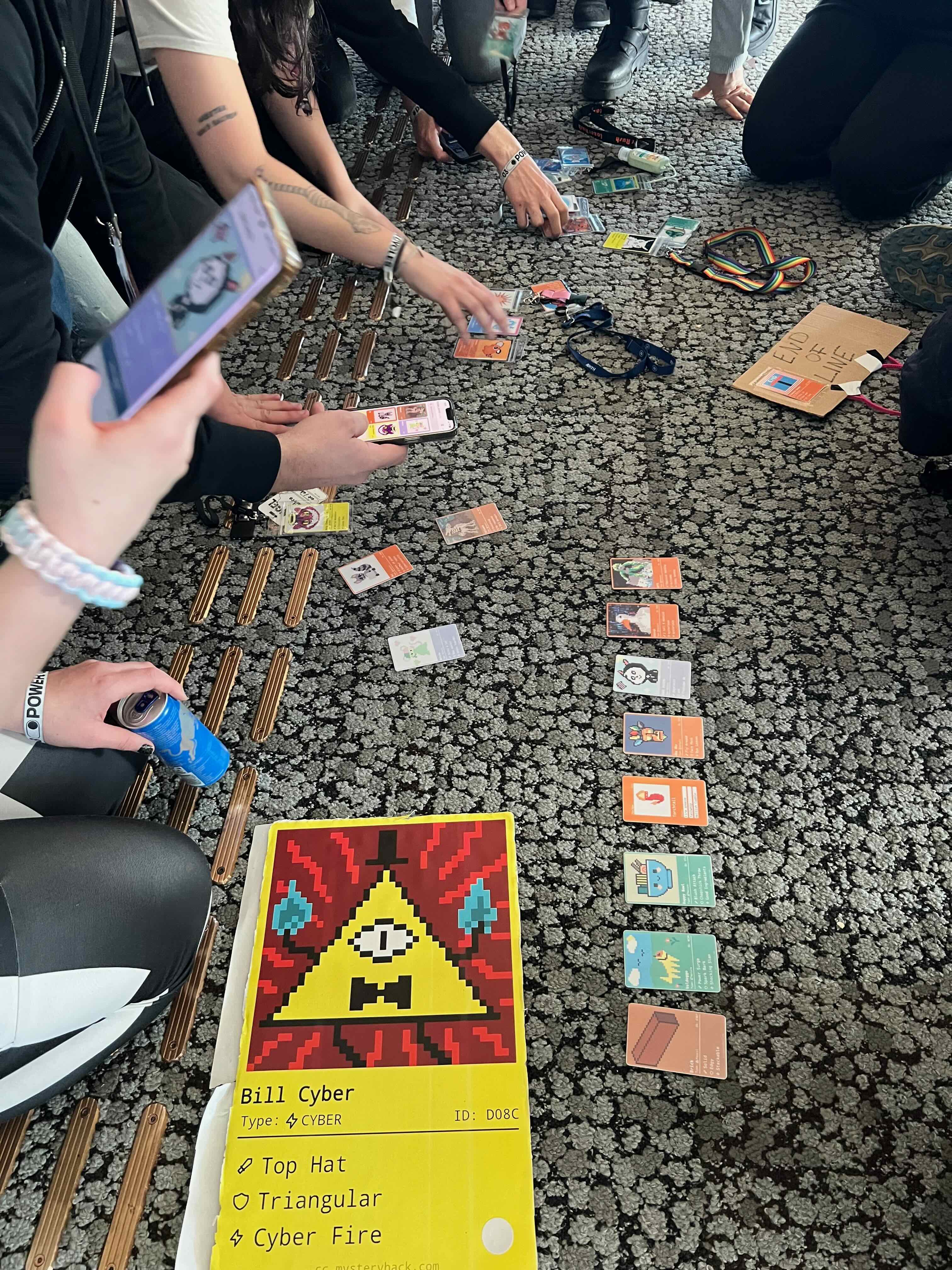 Card exchange meetup with players sharing their creature cards on the floor, including the giant bill cyber card